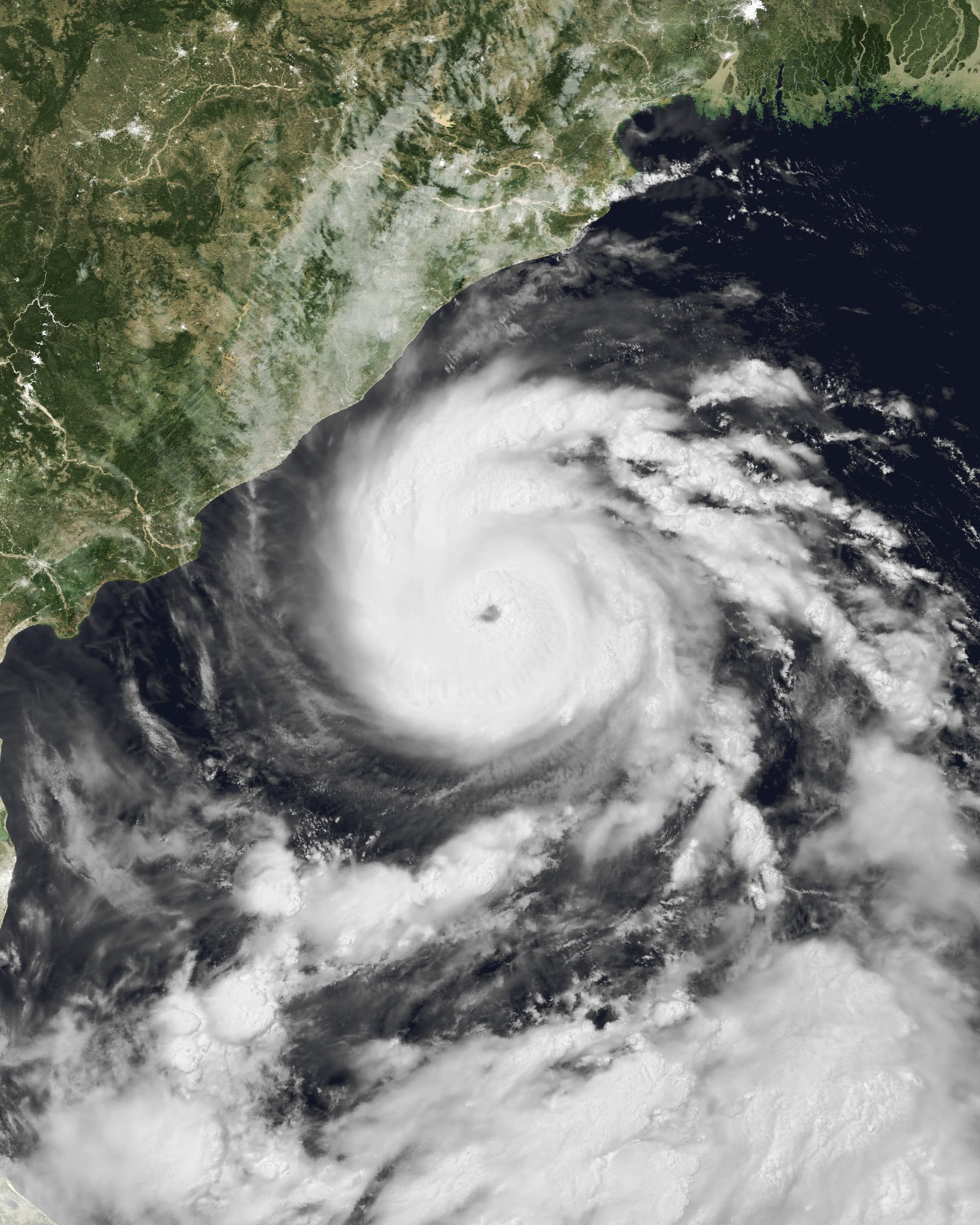 Night-time satellite image of Cyclone Arnab: a huge glowing spiral of cloud with a dark eye over the black Bay of Bengal